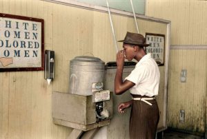 A black man drinking from the Colored water cooler in Oklahoma City in July, 1939 COLOR