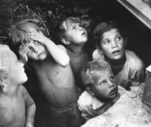 Children in Minsk, Belorussia watching as their neighborhood is bombed in June, 1941