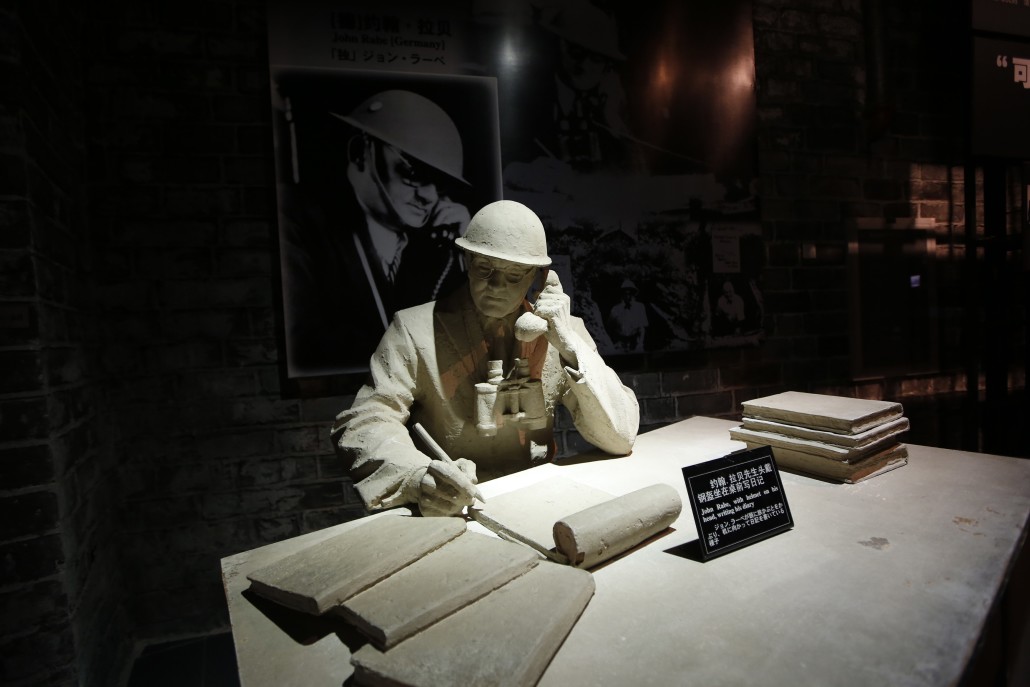 A model and a photograph of John Rabe, sometimes call "China's Schindler", are seen in a museum, during a reporting trip in Nanjing, Jiangsu province February 19, 2014. Rabe, a long-time resident of China from Germany, was head of the International Safety Zone in Nanjing during the December 1937 "Nanjing Massacre" and he is praised for having helped save the lives of more than 200,000 people who took refuge in the Zone. China wants to make World War Two a key part of a trip by President Xi Jinping to Germany next month, much to Berlin's discomfort, diplomatic sources said, as Beijing tries to use German atonement for its wartime past to embarrass Japan. Picture taken February 19, 2014. REUTERS/Aly Song (CHINA - Tags: POLITICS)